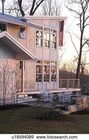 Stock Photo - Contemporary shingle style home at sunset. Fotosearch