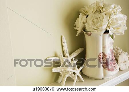 Stock Image - Decorative vase with flowers and starfish. Fotosearch