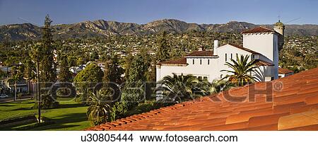 Picture - Detail red tile roof and view of houses on mountainside, panoramic. Fotosearch