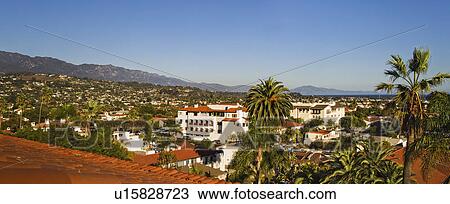 Stock Image - Detail red tile roof and view of houses on mountainside, panoramic. Fotosearch
