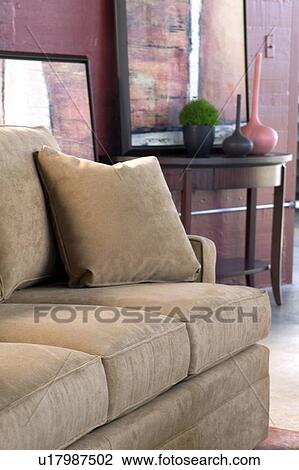 Stock Image - Detail tan sofa with throw pillow. Fotosearch