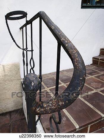 Stock Image - Detail worn wrought iron hand rail. Fotosearch