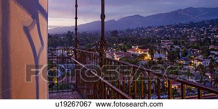 Stock Photo - Detail wrought iron railing of balcony with sunset view of Santa Barbara. Fotosearch