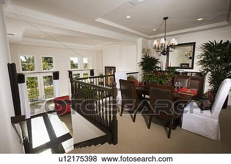 Stock Photo - Dining area at top of steps in contemporary home. Fotosearch