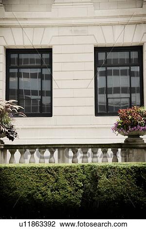 Stock Image - Floral arrangement on railing of terrace. Fotosearch