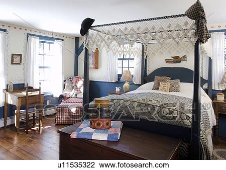 Stock Image - Four post bed in colonial bedroom. Fotosearch