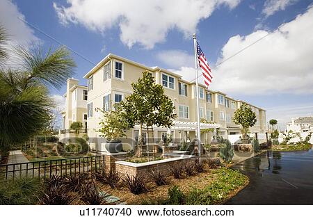 Stock Image - Front exterior contemporary condominiums. Fotosearch