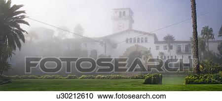 Stock Image - Front exterior Santa Barbara courthouse through the morning fog. Fotosearch