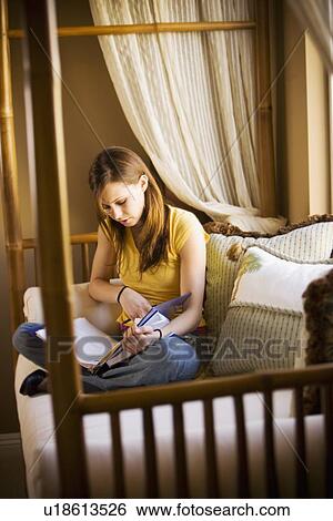 Girl studying on daybed View Large Photo Image Stock Photograph - Girl studying on daybed. Fotosearch