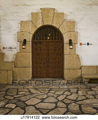 Stock Image - Grand double doors with sandstone arch. Fotosearch