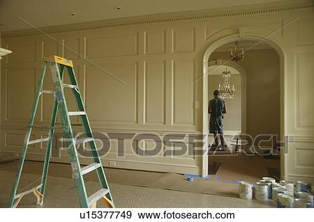 Stock Photo - Ladder in center of traditional home being painted. Fotosearch
