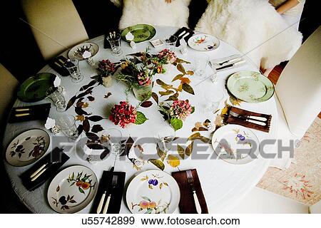 Large circular dining table with several place settings View Large Photo Image Stock Photo - Large circular dining table with several place settings. Fotosearch