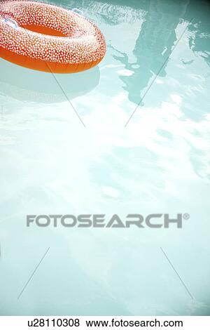 Stock Photo - Orange innertube in swimming pool. Fotosearch