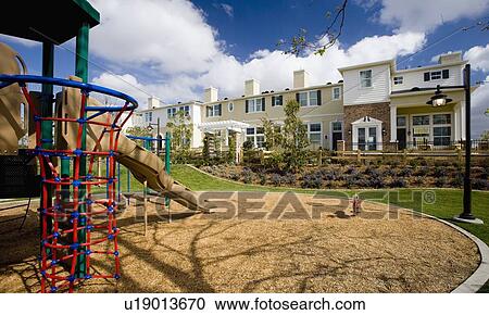 Playground out front of contemporary housing community View Large Photo Image Stock Image - Playground out front of contemporary housing community. Fotosearch