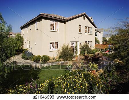 Stock Image - Rear exterior multiple story house. Fotosearch