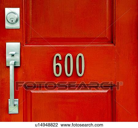 Stock Image - Red door with house number. Fotosearch