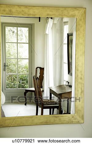 Reflection in mirror of chair at small antique desk View Large Photo Image Stock Image - Reflection in mirror of chair at small antique desk. Fotosearch