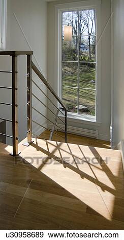 Stock Photo - Shadow from handrail on hardwood floor. Fotosearch