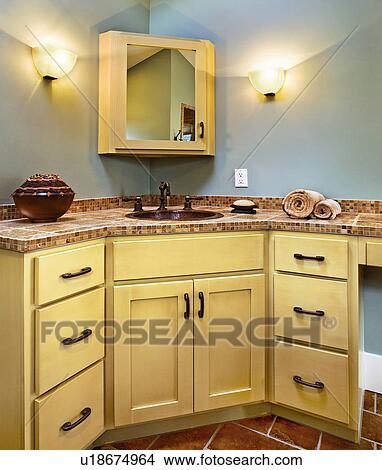 Picture - Sink and cabinets in corner of bathroom. Fotosearch