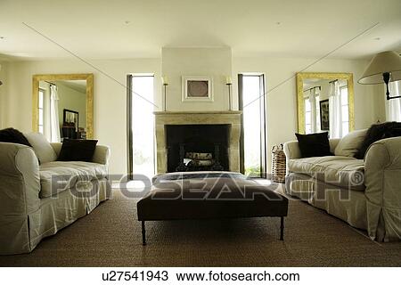 Stock Image - Symmetrical view of traditional living room. Fotosearch