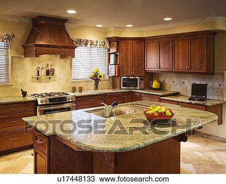 Stock Image - Traditional kitchen with large island and green countertops. Fotosearch