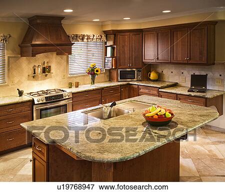 Traditional kitchen with large island and green countertops View Large Photo Image Stock Photo - Traditional kitchen with large island and green countertops. Fotosearch