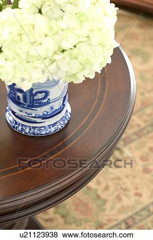 Stock Photo - Vase of flowers on round table. Fotosearch