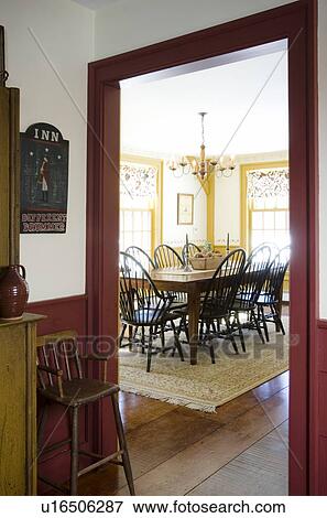 Stock Photo - View through doorway colonial style dining room. Fotosearch
