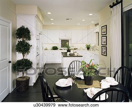 Stock Photo - White kitchen with dining area. Fotosearch