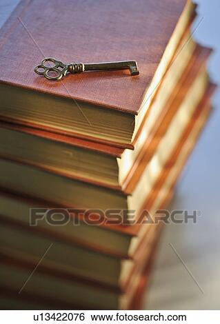 Antique books and key View Large Photo Image Stock Photograph - Antique books and key. Fotosearch