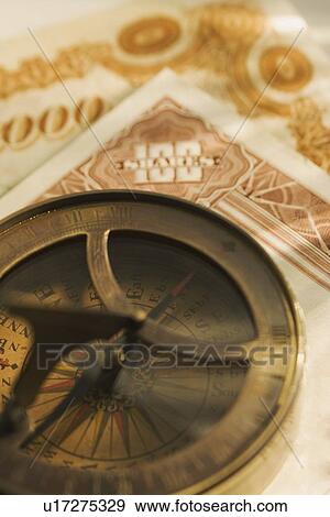 Stock Photo - Antique compass and corporate bonds. Fotosearch