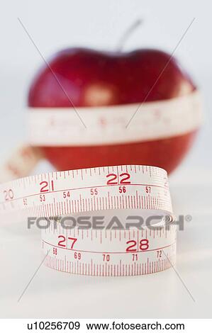 Apple wrapped in tape measure View Large Photo Image Stock Photo - Apple wrapped in tape measure. Fotosearch