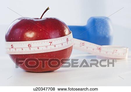 Apple wrapped in tape measure View Large Photo Image Stock Photo - Apple wrapped in tape measure. Fotosearch