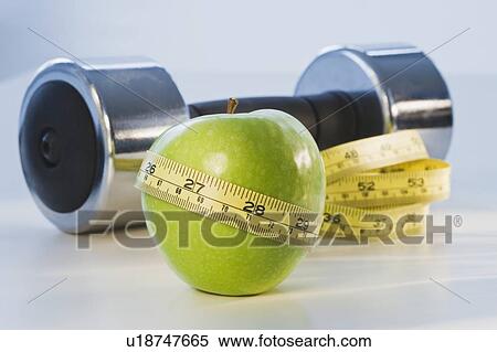 Apple wrapped in tape measure View Large Photo Image Stock Photography - Apple wrapped in tape measure. Fotosearch