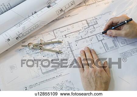 Stock Photo - Architect drawing blueprints. Fotosearch