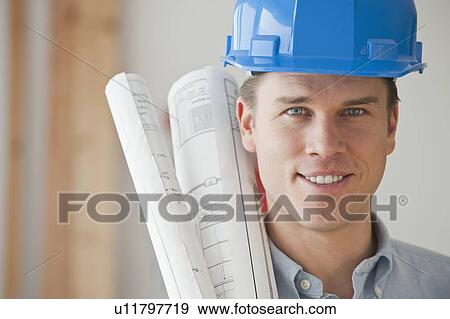 Architect holding blueprints View Large Photo Image Stock Photo - Architect holding blueprints. Fotosearch