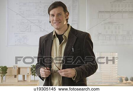 Stock Photography - Architect posing in office. Fotosearch