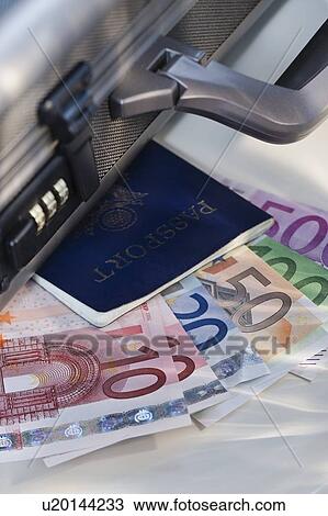 Stock Image - Assorted euro notes and passport. Fotosearch