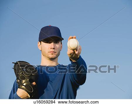 Baseball player holding ball View Large Photo Image Picture - Baseball player holding ball. Fotosearch