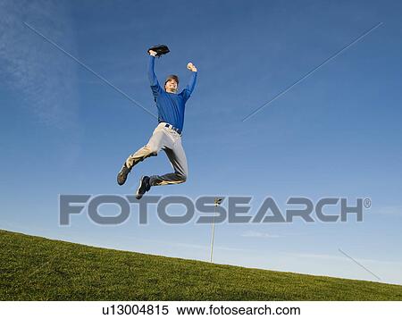 Baseball player jumping in air View Large Photo Image Stock Photography - Baseball player jumping in air. Fotosearch