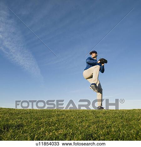 Stock Image - Baseball player throwing ball. Fotosearch
