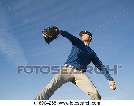 Stock Photo - Baseball player throwing ball. Fotosearch