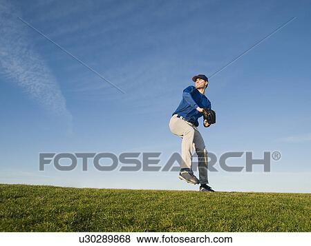 Stock Photo - Baseball player throwing ball. Fotosearch