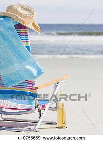 Stock Photo - Beer next to beach chair. Fotosearch