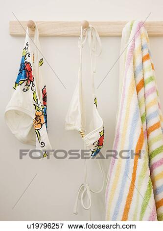 Stock Photo - Bikini and towel hanging on rack. Fotosearch