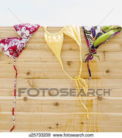 Stock Photo - Bikinis drying on fence. Fotosearch