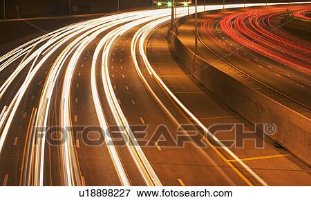 Stock Photo - Blurred traffic headlights at night. Fotosearch