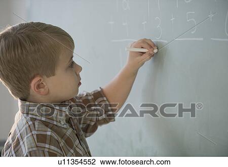 Boy doing math on blackboard View Large Photo Image Stock Image - Boy doing math on blackboard. Fotosearch
