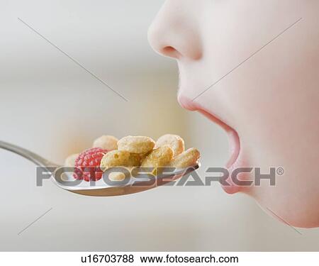 Stock Photo - Boy eating cereal. Fotosearch