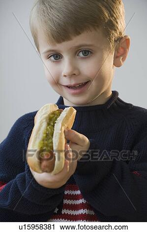 Boy eating hot dog View Large Photo Image Stock Image - Boy eating hot dog. Fotosearch